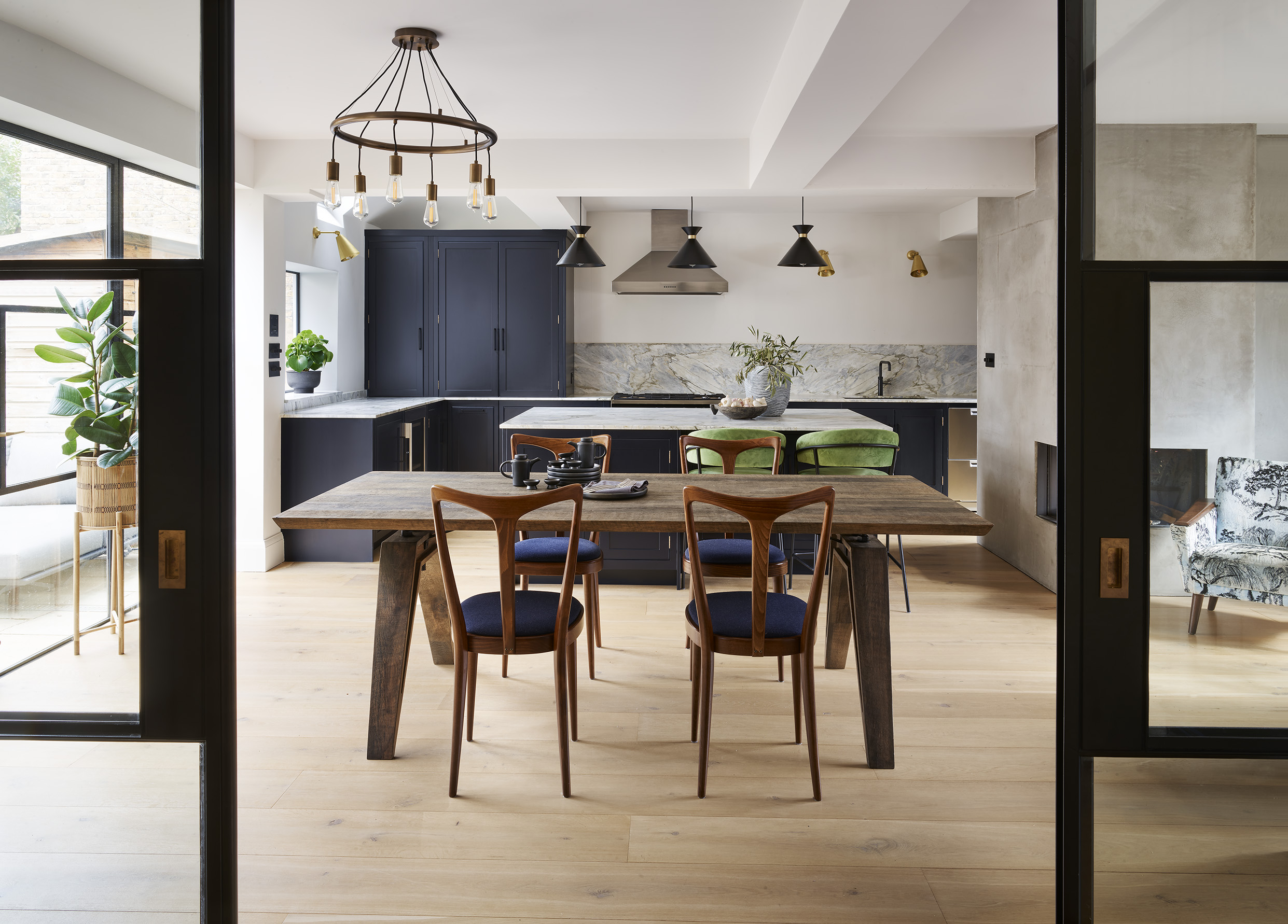 Navy blue kitchen diner with wood accents and crittall sliding doors