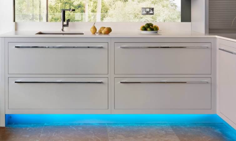 Off white kitchen cabinetry with lighting under the cabinets