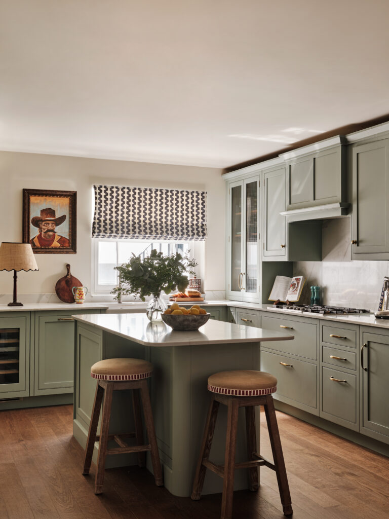 Sage green modern kitchen design with small island and natural wood features