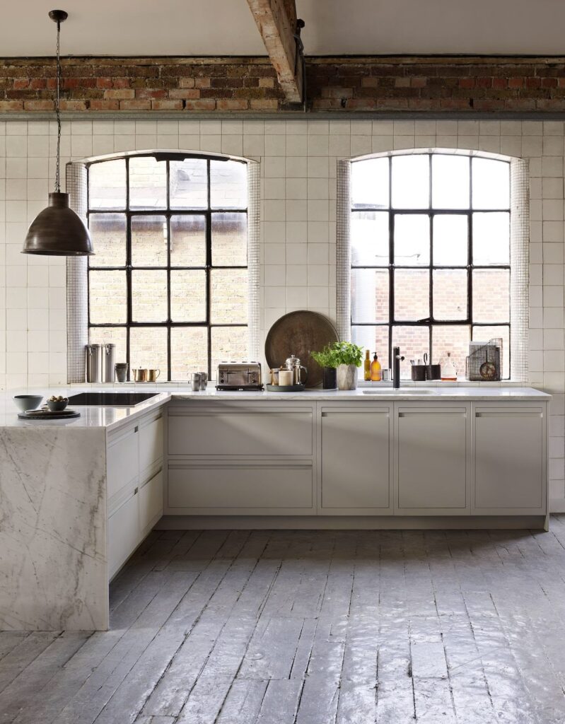 Industrial kitchen in a warehouse with handleless kitchen cabinetry