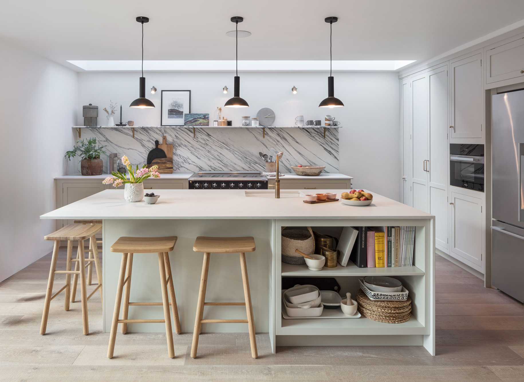 Neutral modern kitchen with island, natural wood features and marble splashback