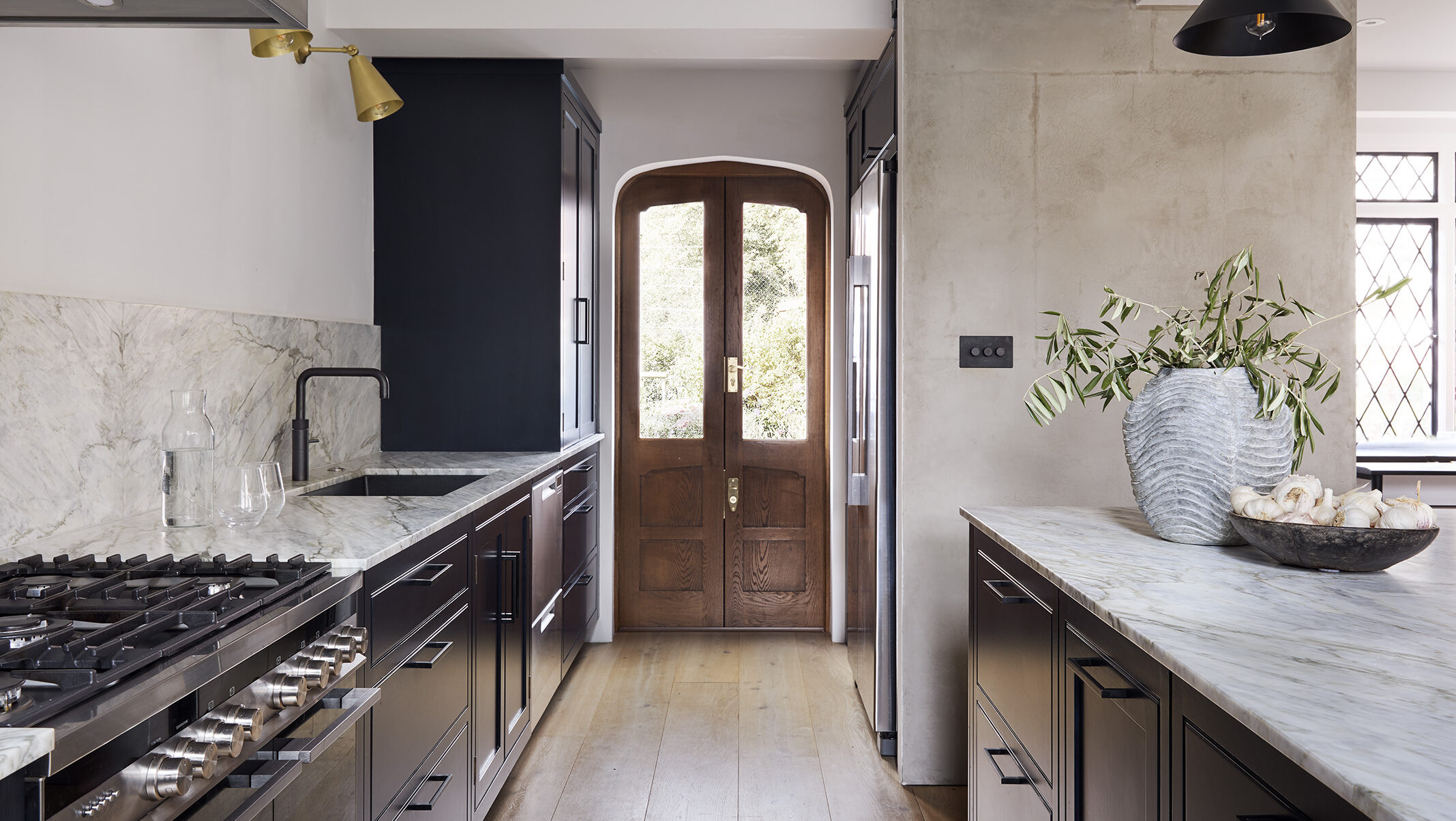 Navy blue period home kitchen with marble countertops and range cooker