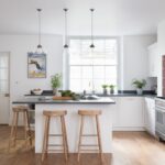 Harvey Jones White Srbor kitchen featuring black worktops and wooden smile stools around a kitchen island