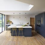 Open plan Linear kitchen featuring blue cabinetry and white worktops