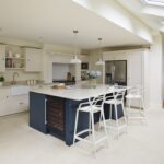 Classic Original kitchen design featuring a blue kitchen island and white kitchen cabinetry