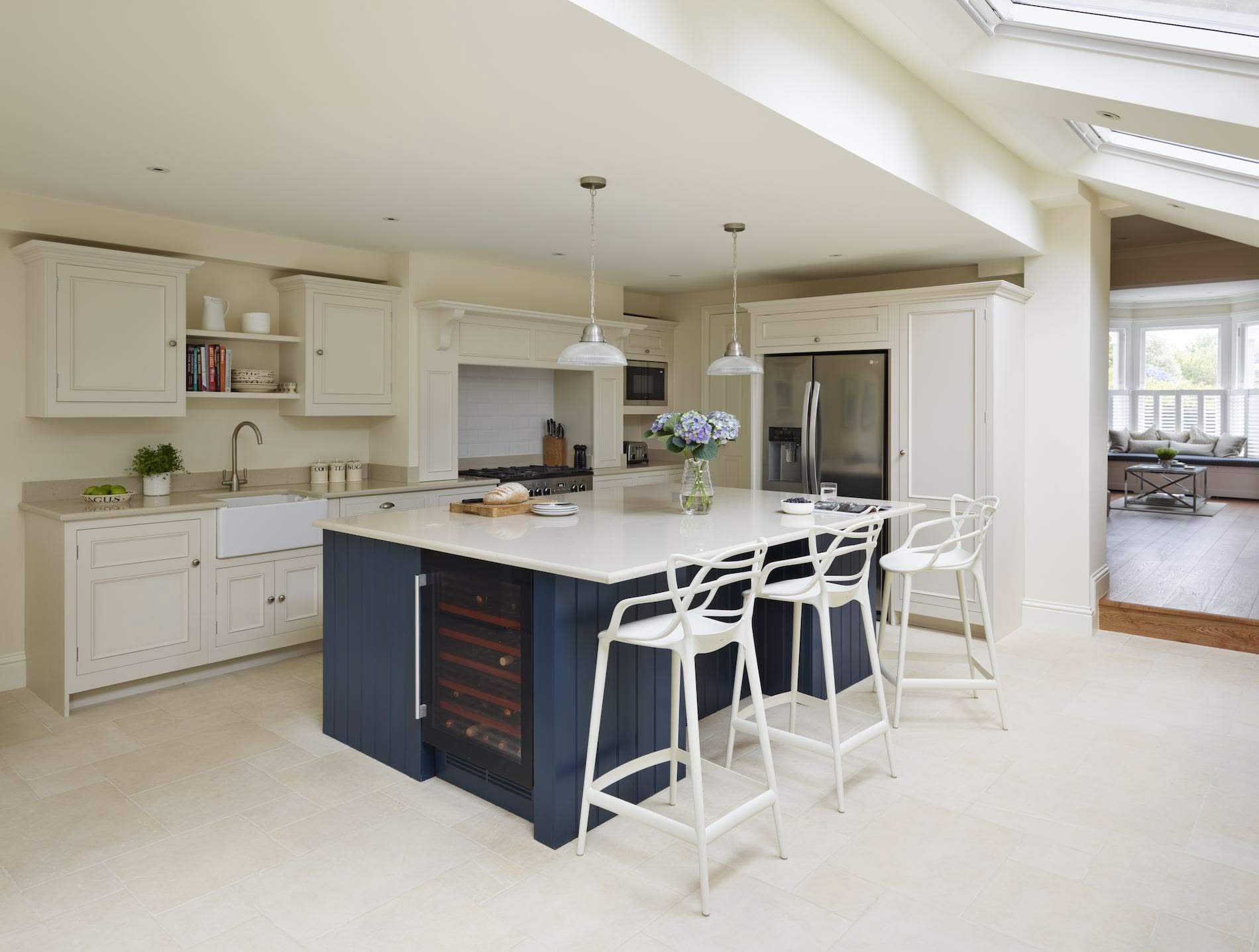 Classic Original kitchen design featuring a blue kitchen island and white kitchen cabinetry