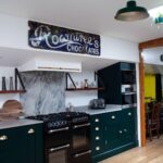Rich green Shaker kitchen design on a houseboat