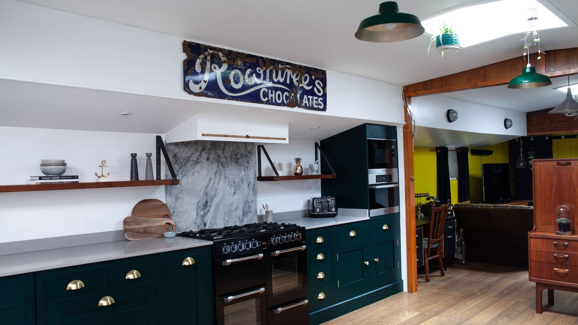 Rich green Shaker kitchen design on a houseboat