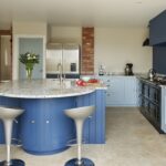 Blue curved kitchen island with granite worktop