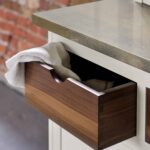 Walnut kitchen drawer with walnut interior open to show organised storage