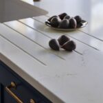 Closeup of white marble kitchen worktop with drainer grooves