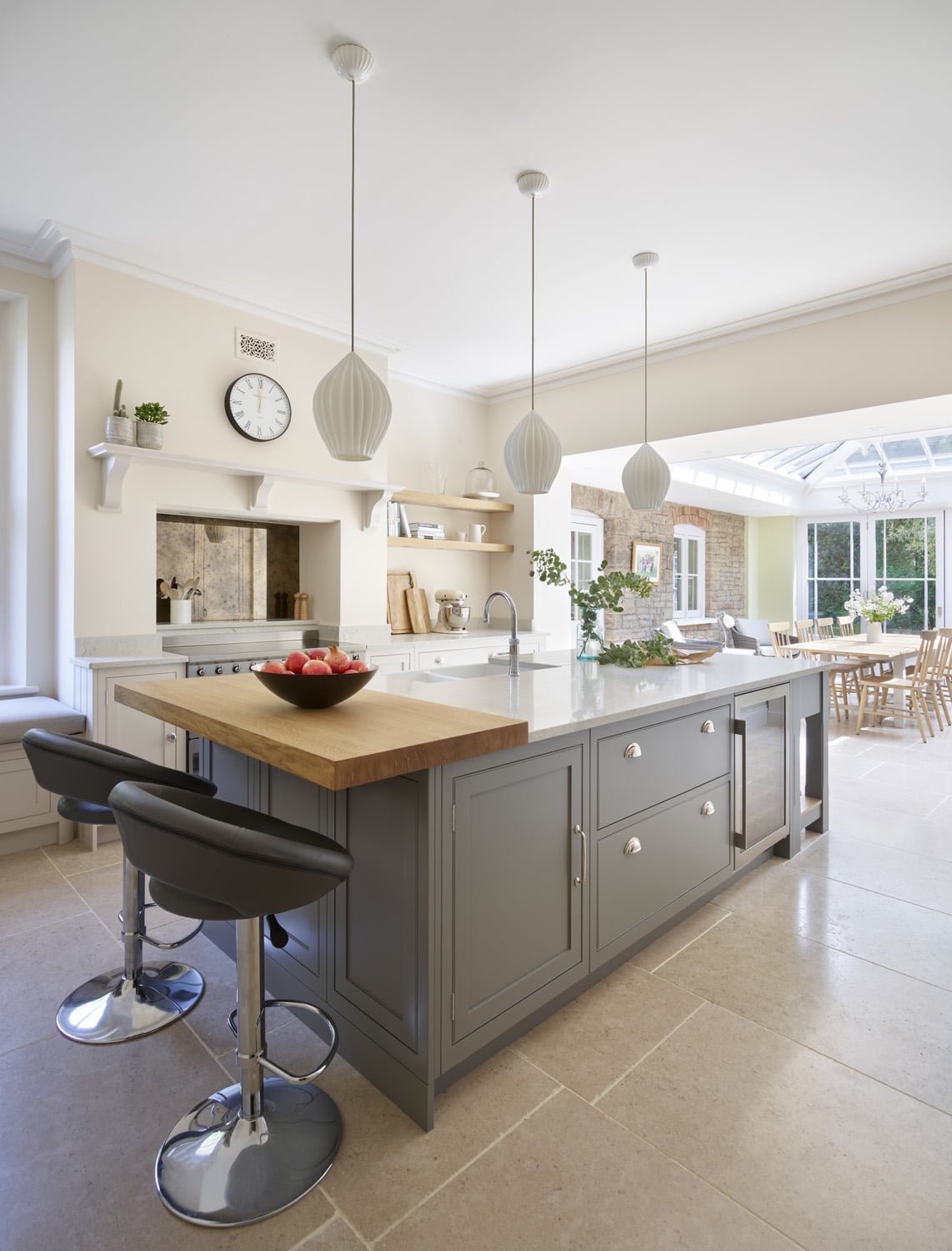 Grey kitchen island and white cabinetry featuring grey marble worktops