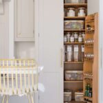 White tall pantry with double doors open to show organised storage