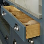 Blue kitchen drawer with oak interior open to show organised cutlery storage