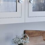 Closeup of white Arbor kitchen cabinetry with round silver handles