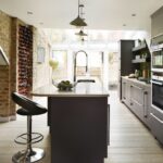 Dark grey kitchen island with cream worktop and integrated sink