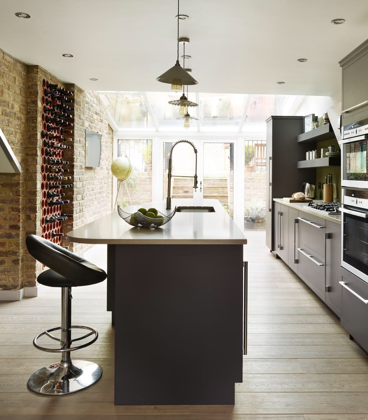 Dark grey kitchen island with cream worktop and integrated sink