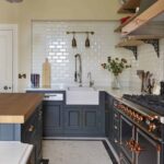 Dark Original kitchen cabinetry with copper handles