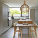 Open plan dining area with a Linear Edge kitchen in natural colours