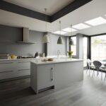 Grey Linear kitchen design next to open plan dining area
