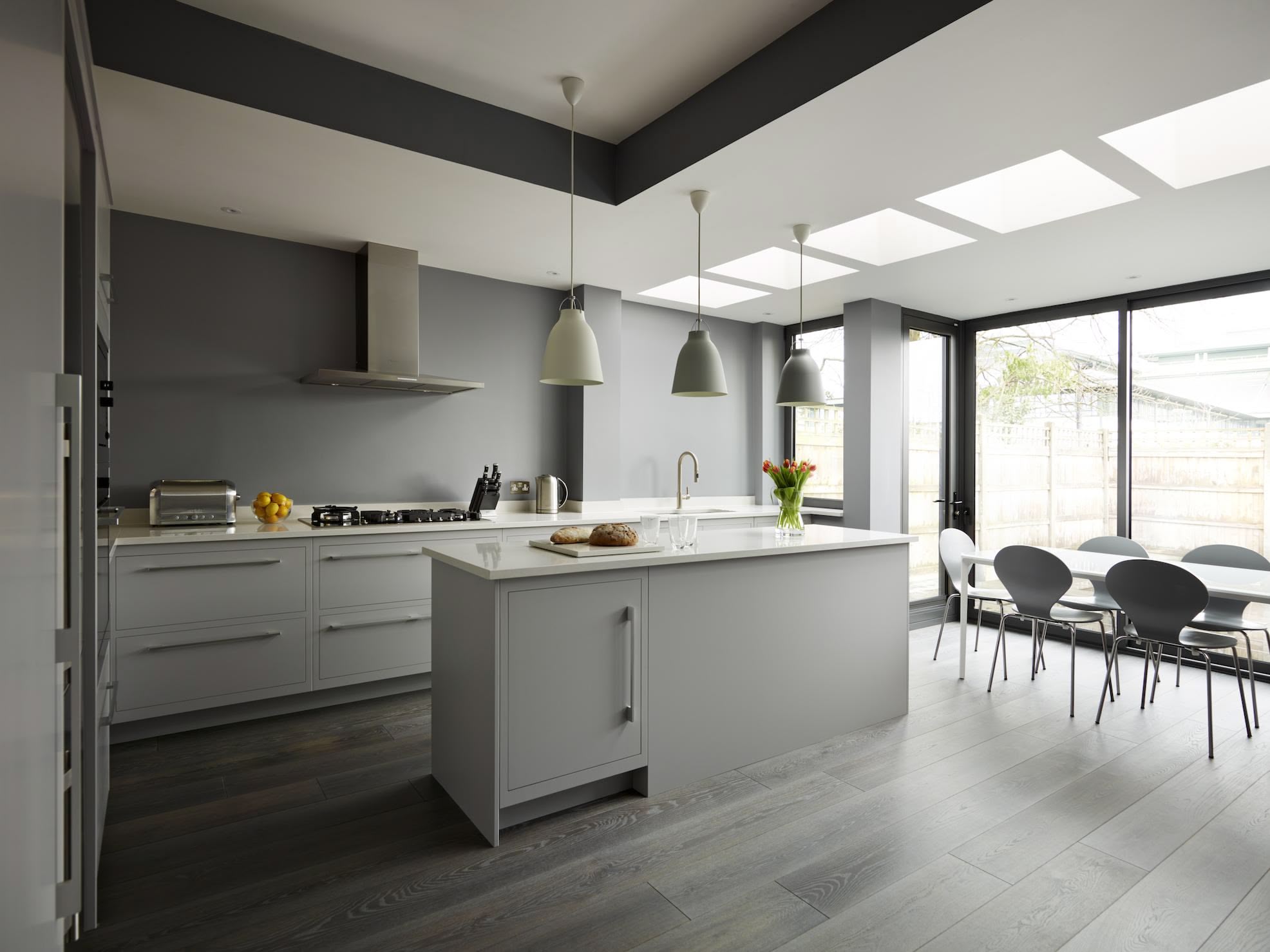 Grey Linear kitchen design next to open plan dining area