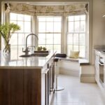 Walnut Shaker kitchen island overlooking bench seating against a large window