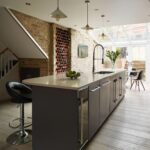 Dark grey kitchen island with cream worktop and integrated sink