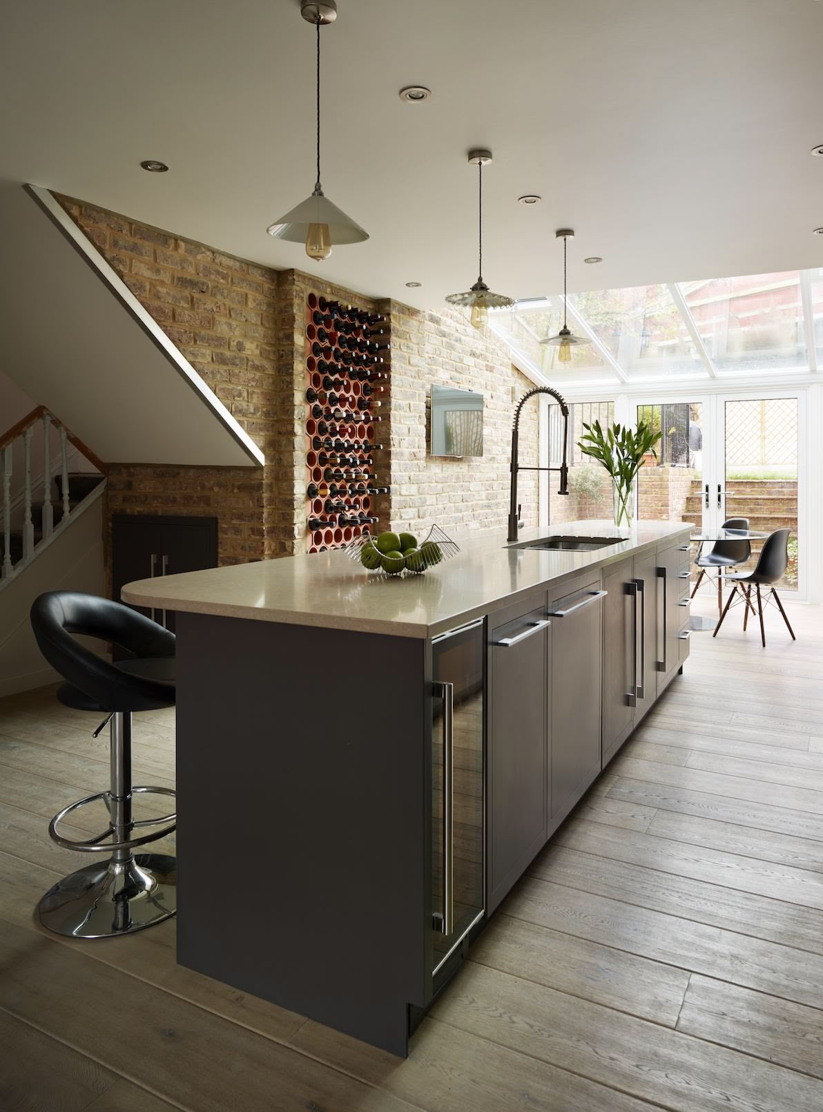 Dark grey kitchen island with cream worktop and integrated sink