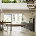 Open plan low level kitchen design next to stairs