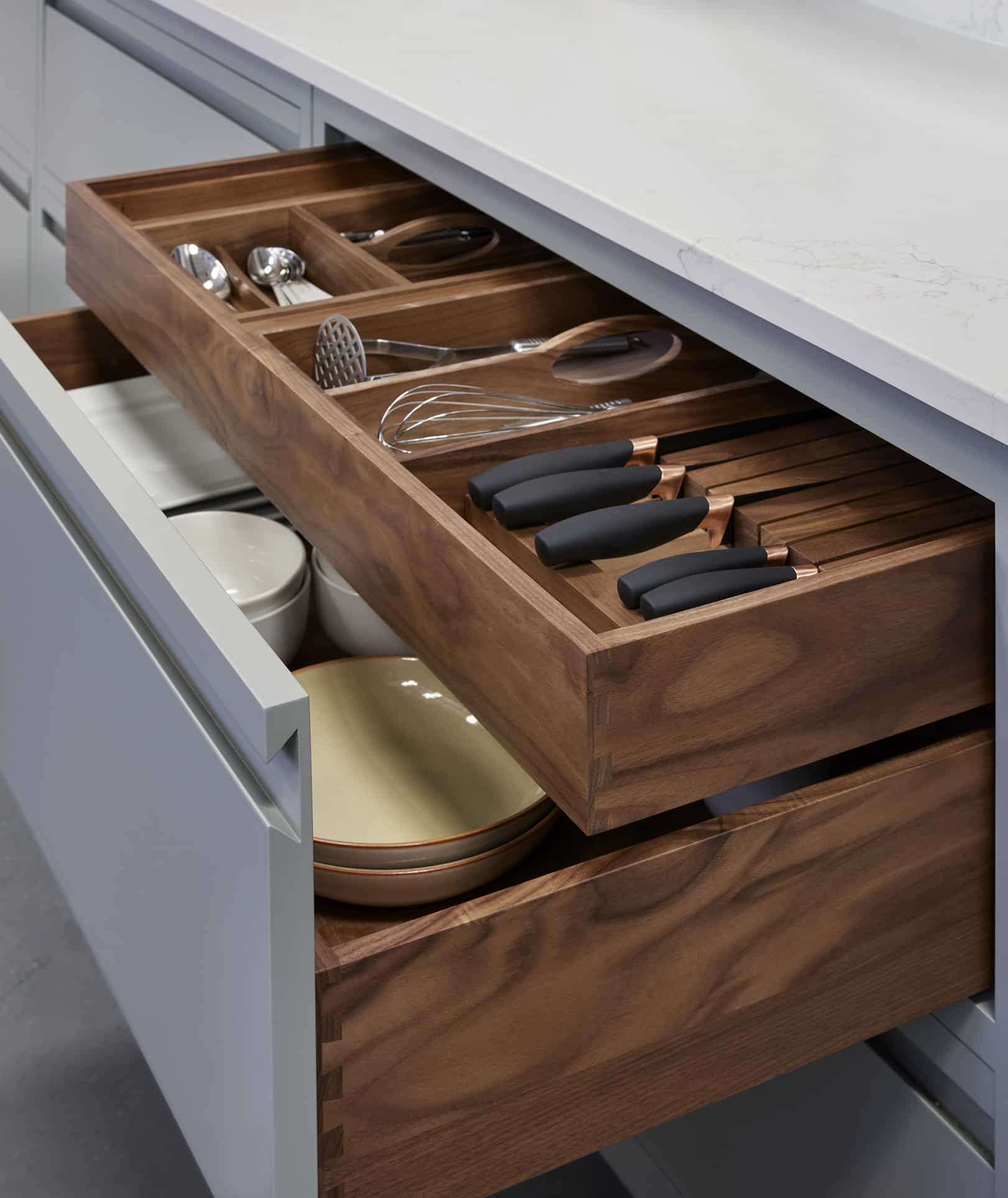 Green-grey Linear edge kitchen drawer open to reveal dark oak cutlery dividers