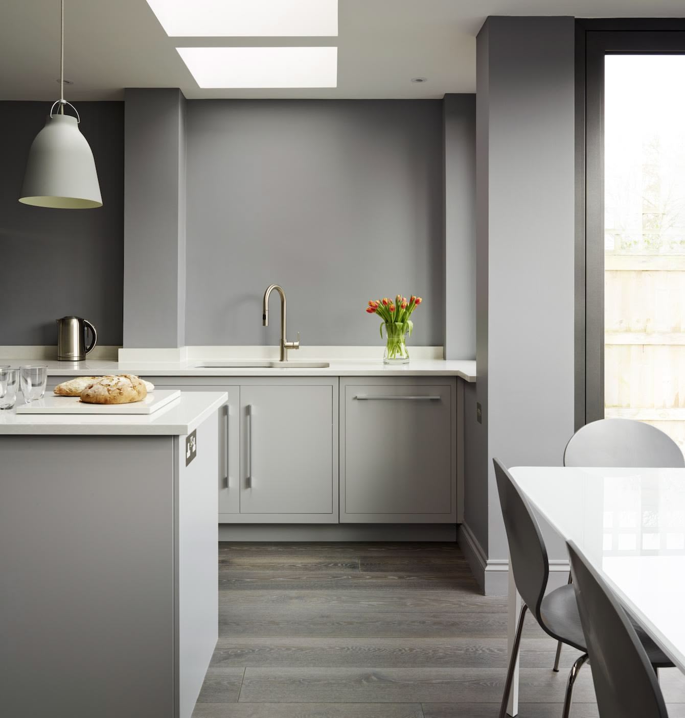Grey Linear kitchen design next to open plan dining area