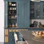 Rich blue Arbor kitchen cabinetry open revealing organised storage