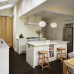 Low level kitchen design with white cabinetry