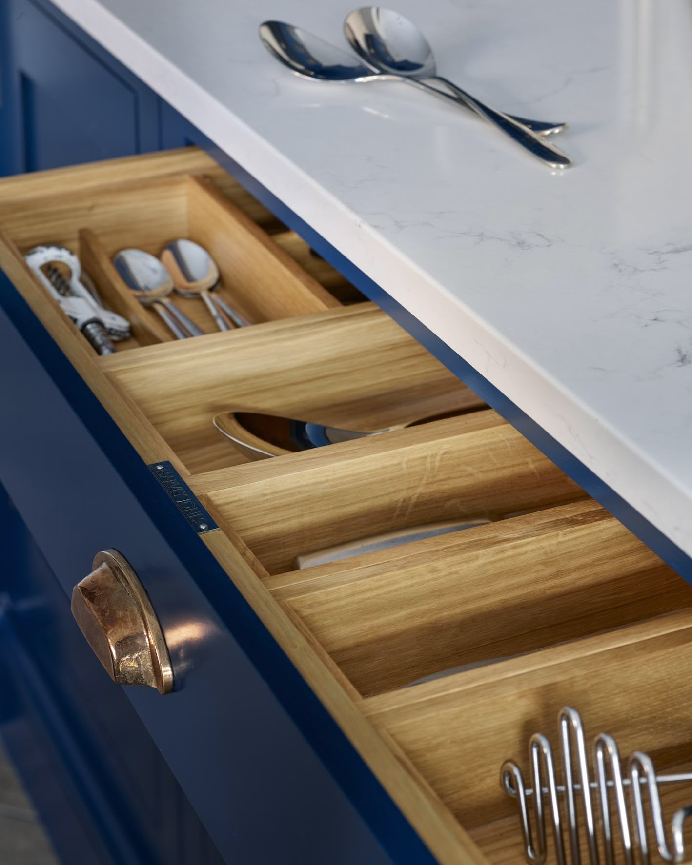 Blue kitchen drawer with oak interior open to show organised cutlery storage
