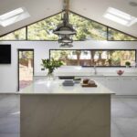 White marble kitchen island end and white worktop