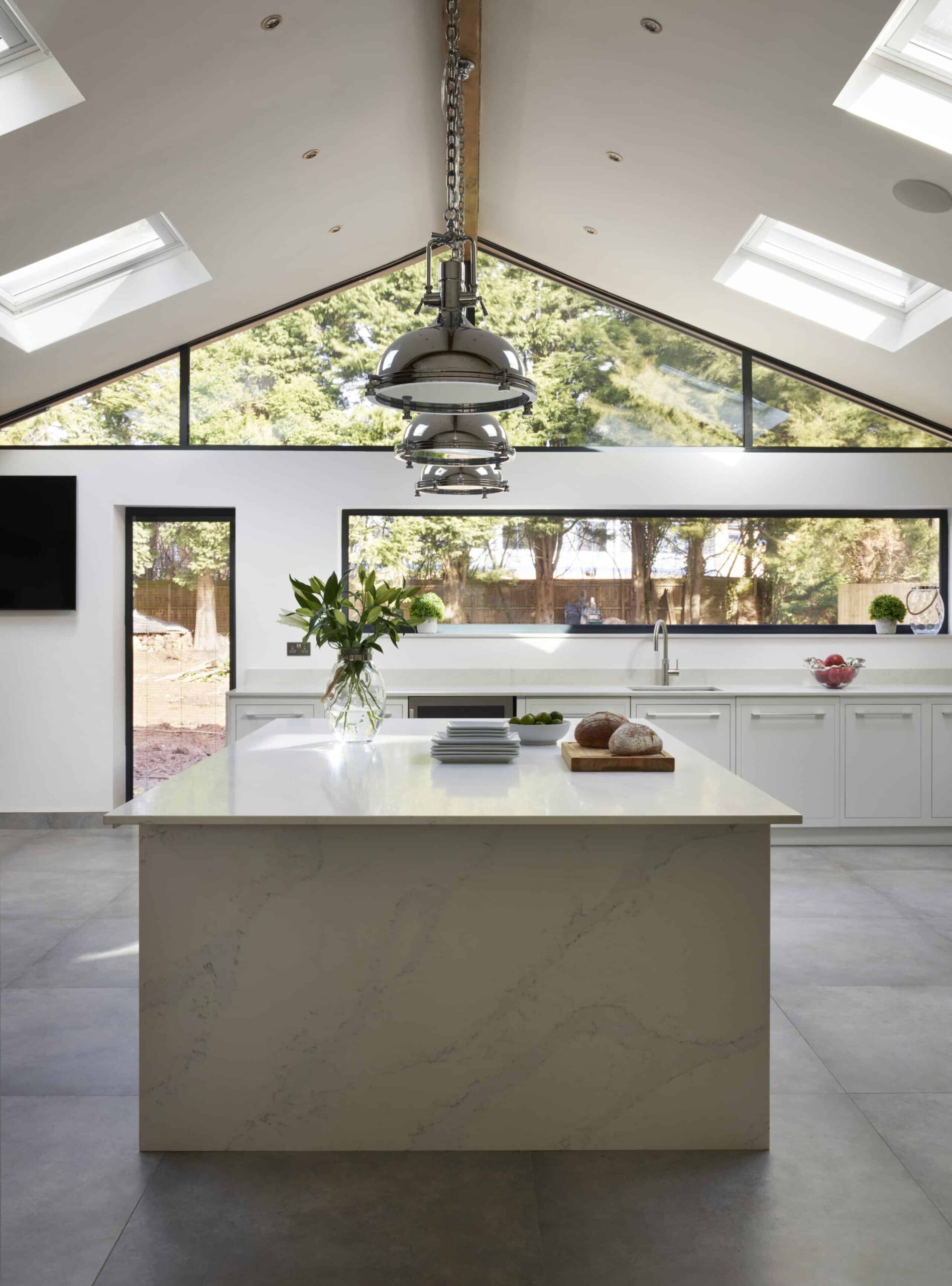 White marble kitchen island end and white worktop