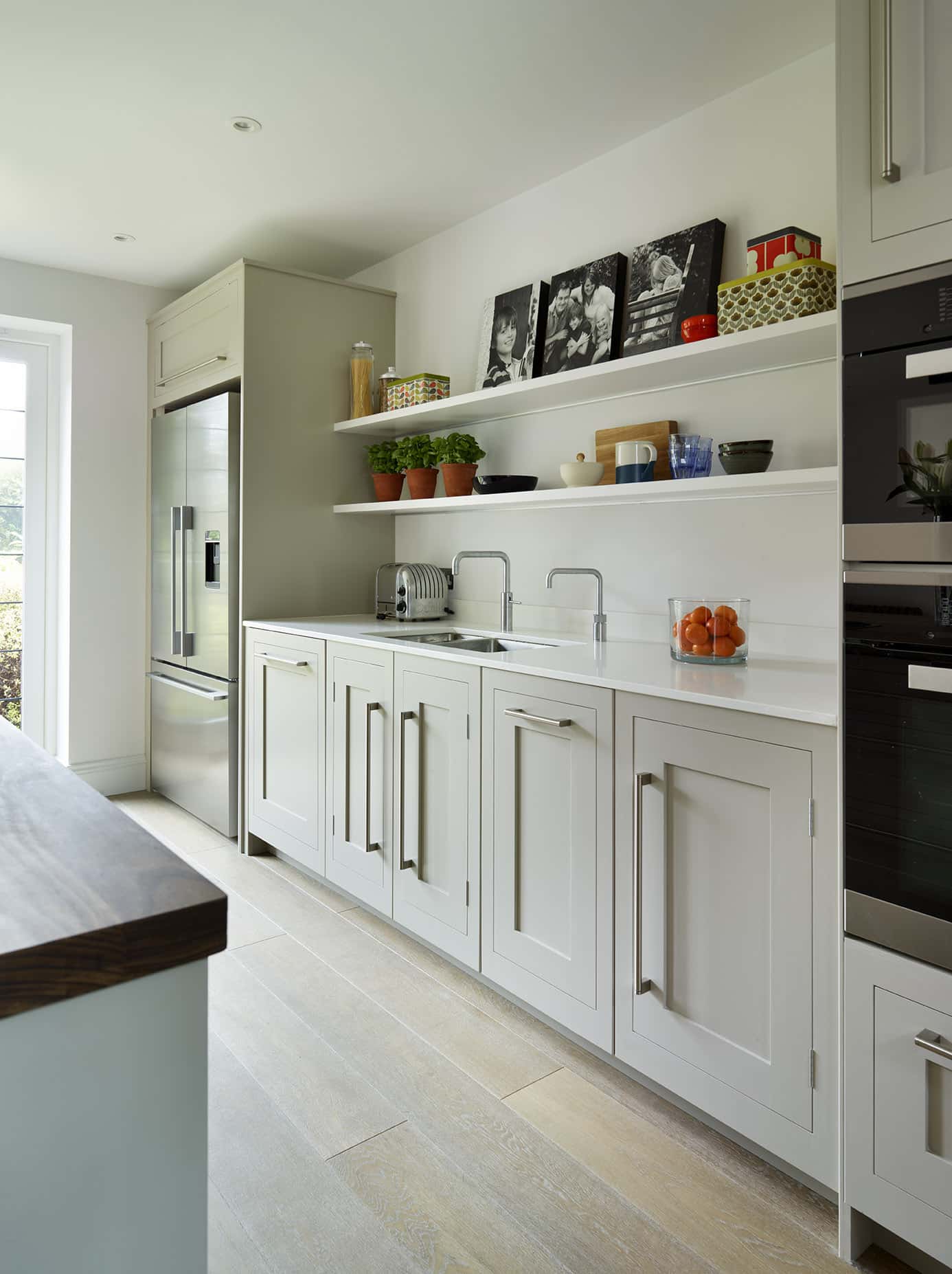 White Shaker kitchen cabinetry with white worktops