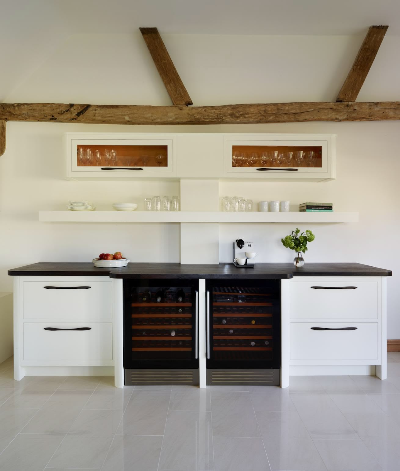 White Linear kitchen cabinetry with black worktop featuring wine storage