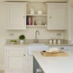 Cream kitchen cabinetry with white sink and silver tap
