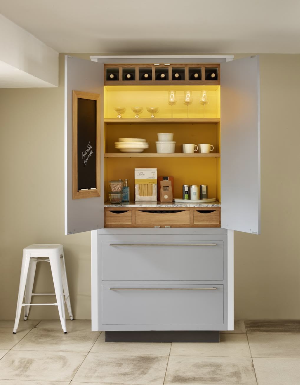 Large white pantry unit open to reveal organised shelving and drawers