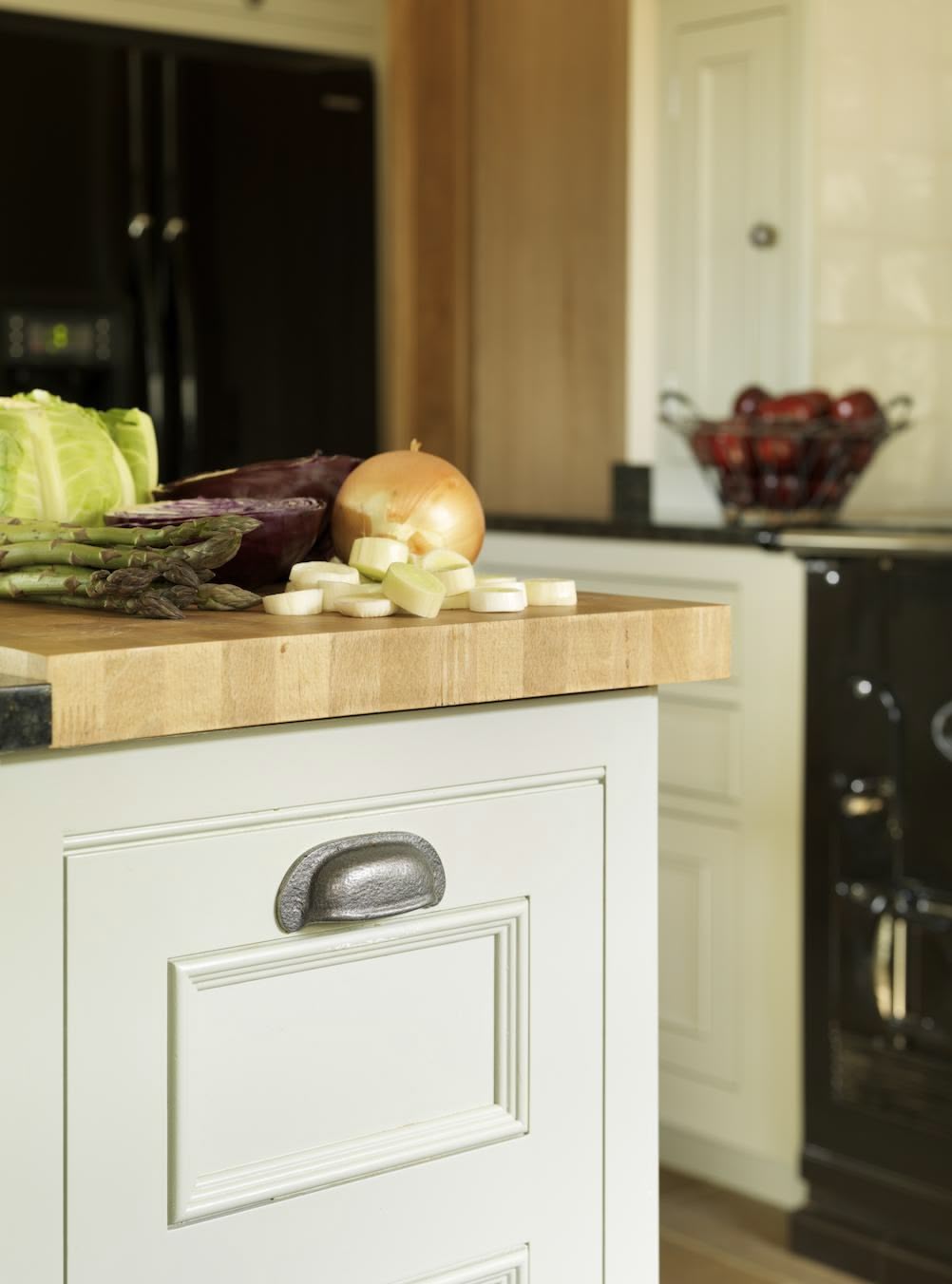 Closeup of sage green kitchen island drawer in Original design with silver handles