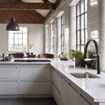 Beige Linear edge kitchen cabinetry with white marble worktop featuring sink and integrated hob