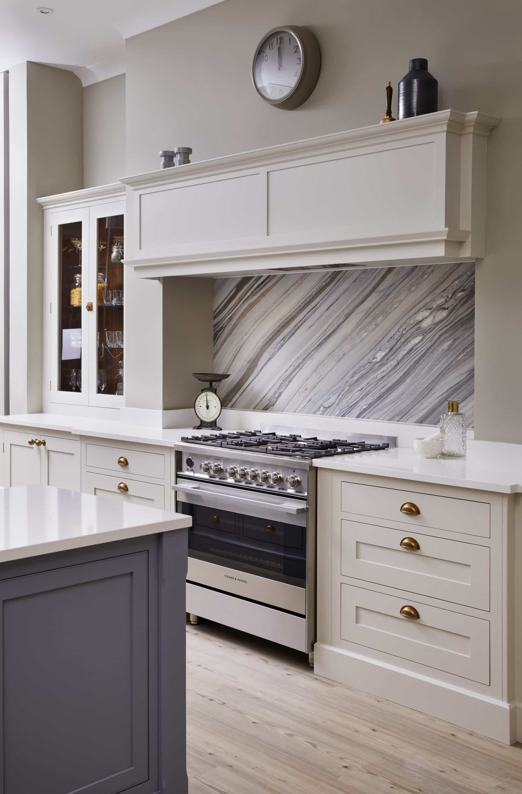 White Original kitchen cabinetry with white worktop featuring white and grey marble splashback against the cooker