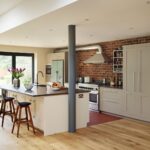 Shaker kitchen design featuring exposed brick wall