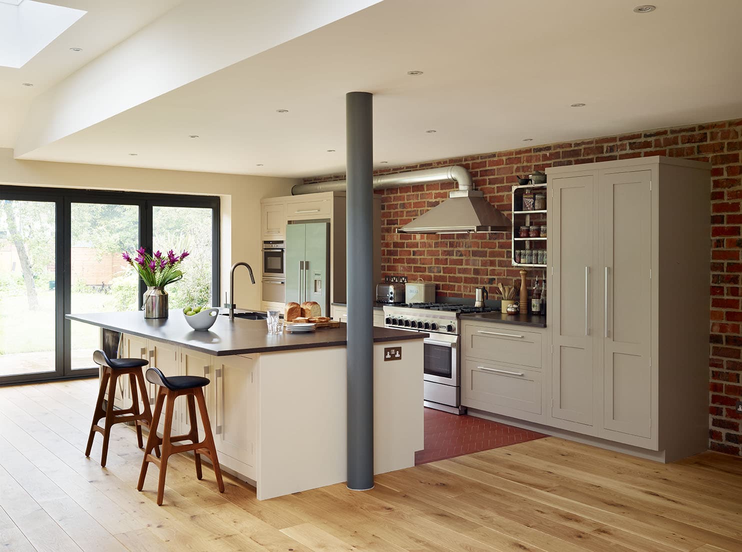 Shaker kitchen design featuring exposed brick wall