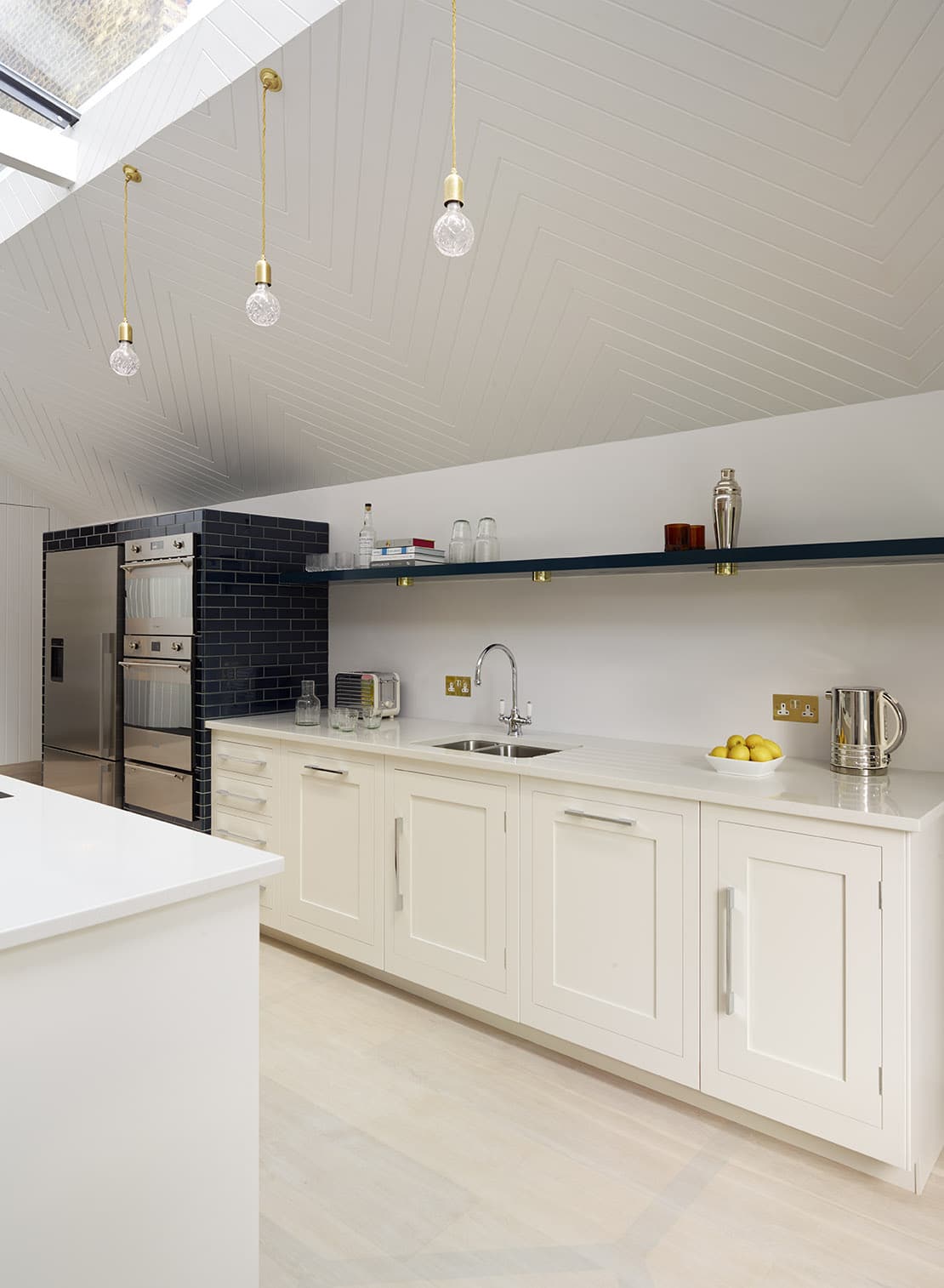 Bright white Shaker kitchen cabinetry with white worktop