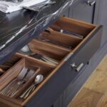 Black kitchen drawer with walnut interior open to show organised cutlery storage
