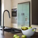 Dark grey kitchen island worktop with integrated sink and dark grey tap