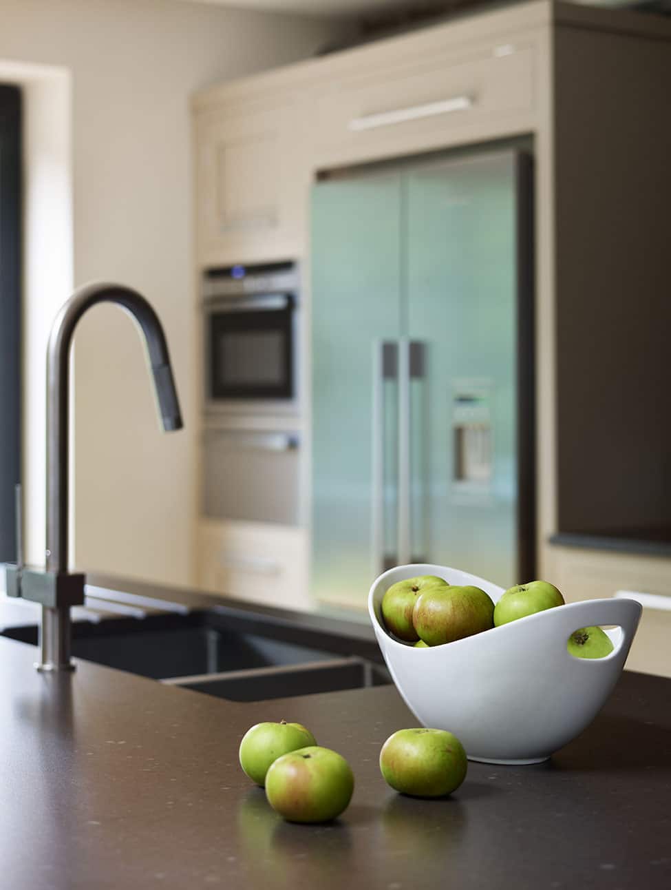 Dark grey kitchen island worktop with integrated sink and dark grey tap