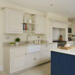 Cream kitchen cabinetry with white sink and silver tap